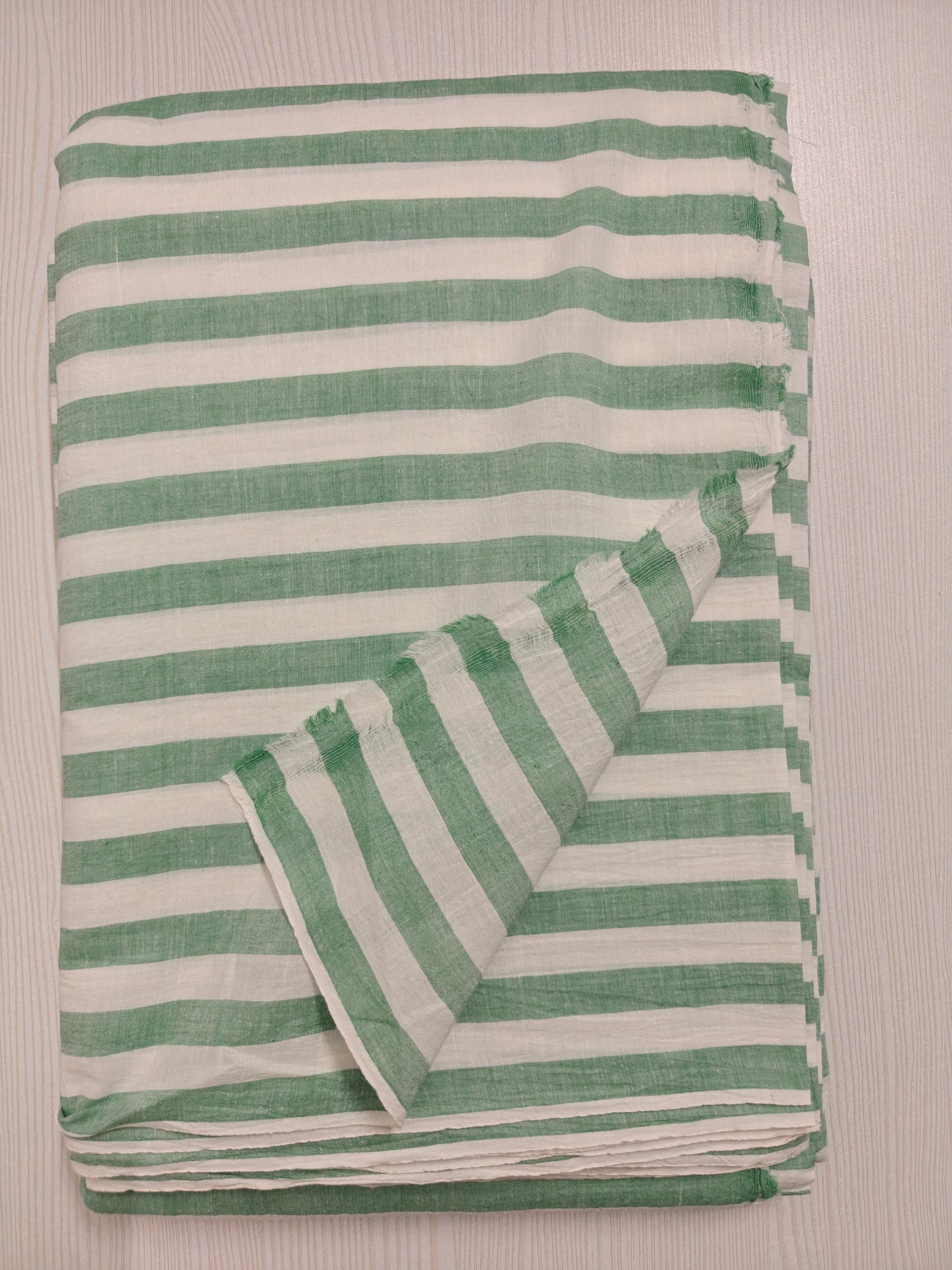Handwoven green and white striped cotton fabric – breathable and perfect for shirts, dresses, and sustainable fashion.