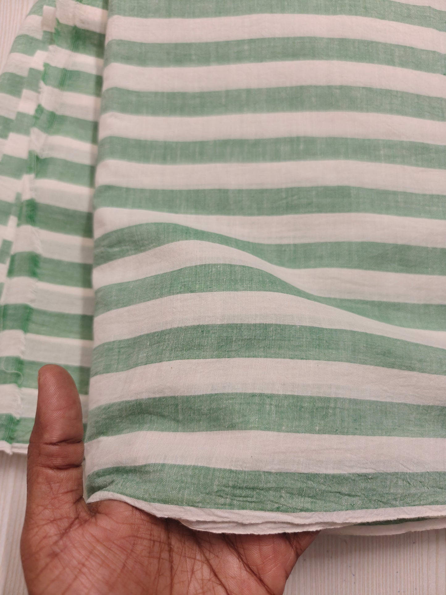 Sustainable striped green cotton fabric – sold by the meter for conscious clothing.