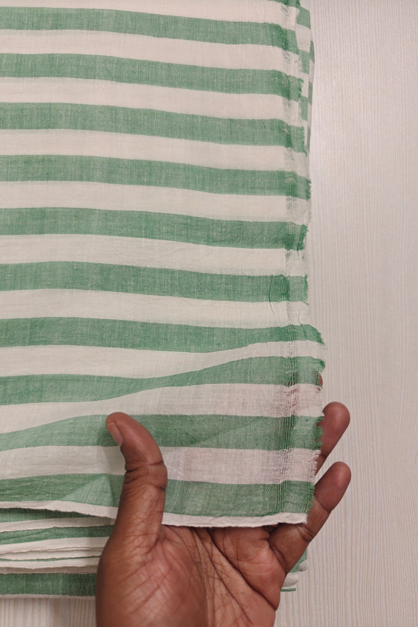Eco-friendly green striped handspun cotton textile – ideal for modern fashion designers.
