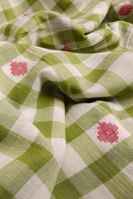 Handwoven green and white plaid cotton fabric with pink jamdani motifs, yarn-dyed and made with azo-free dyes in India