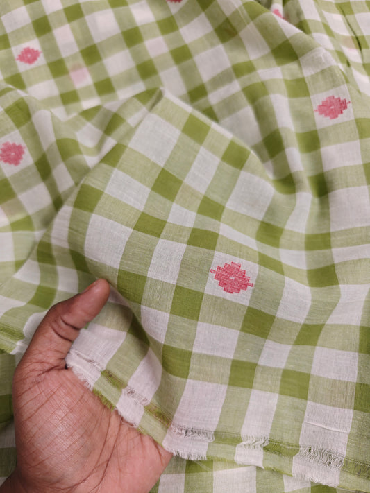 Handwoven green and white plaid cotton fabric with pink jamdani motifs, yarn-dyed and made with azo-free dyes in India  