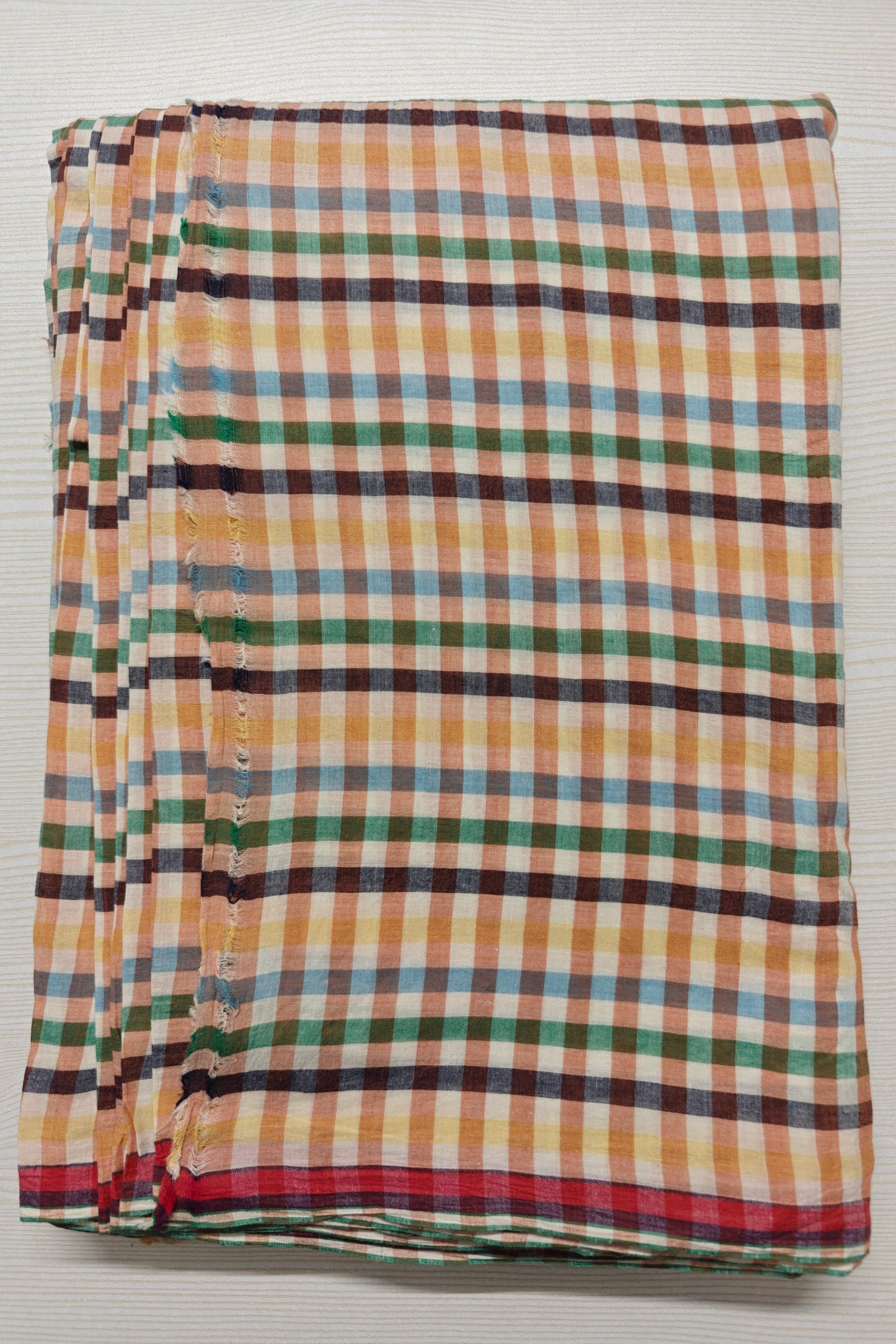 Multicolor handwoven cotton checks for conscious designers. Artisan-made, azo-free, and yarn-dyed. Sustainable fabric for playful, vibrant designs.