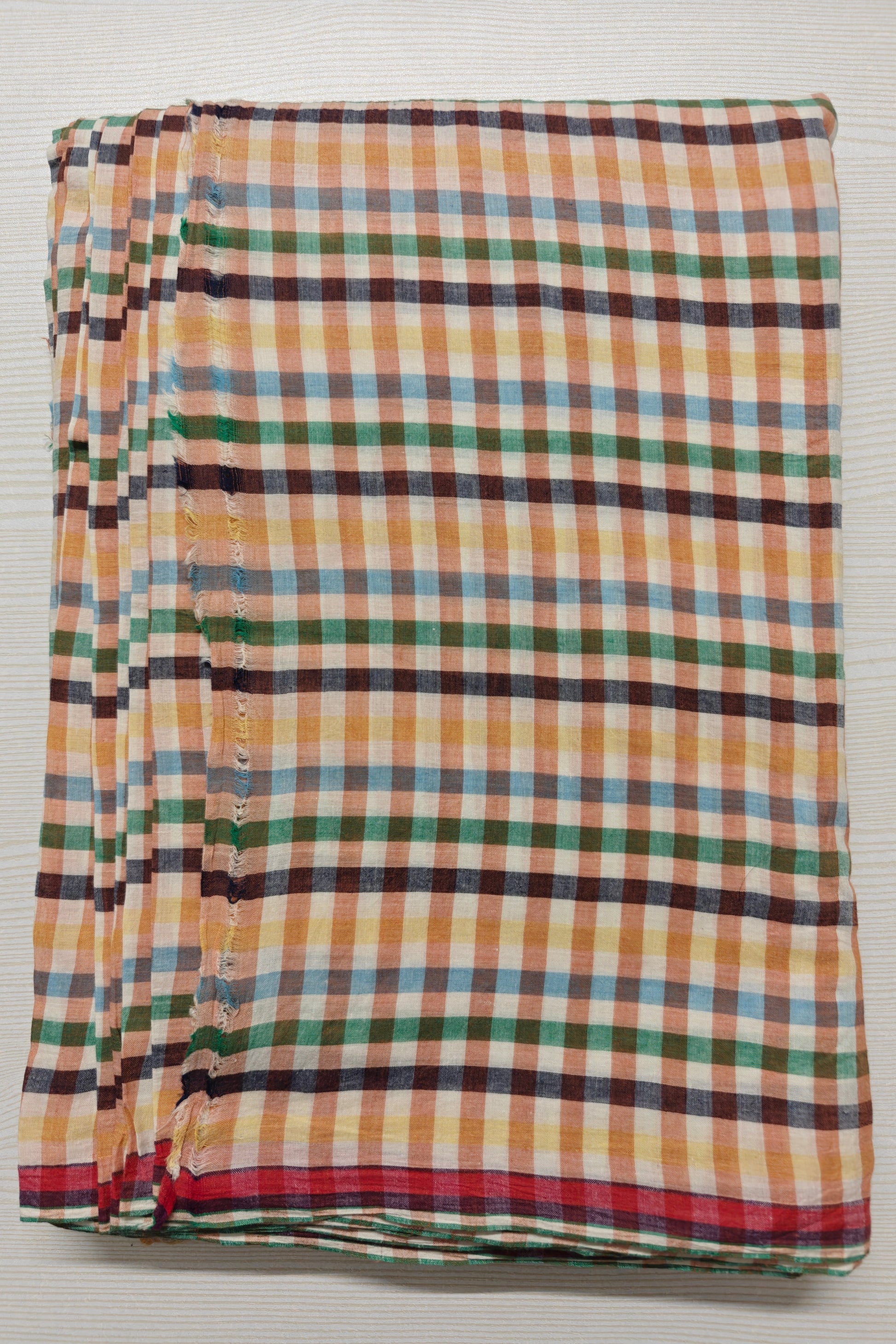 Multicolor handwoven cotton checks for conscious designers. Artisan-made, azo-free, and yarn-dyed. Sustainable fabric for playful, vibrant designs.