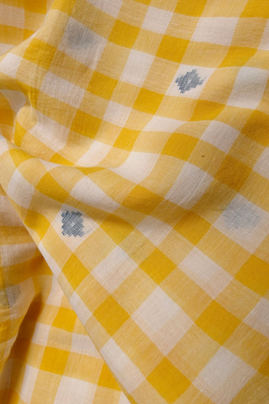 Handwoven yellow plaid cotton with indigo jamdani. Naturally dyed and artisan-made in India. Ideal for conscious fashion and textile designers.