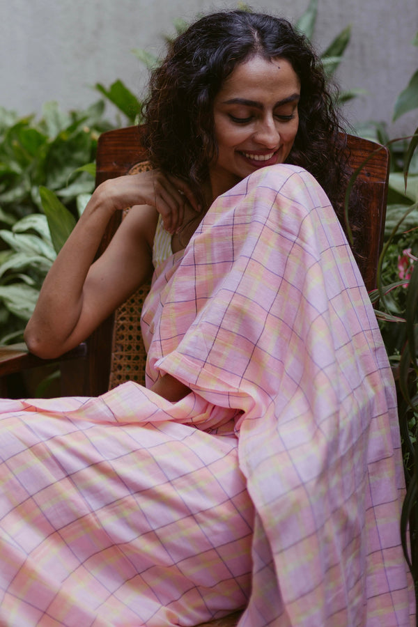 Woman in pastel pink cotton saree with yellow checks – handwoven Bengal saree