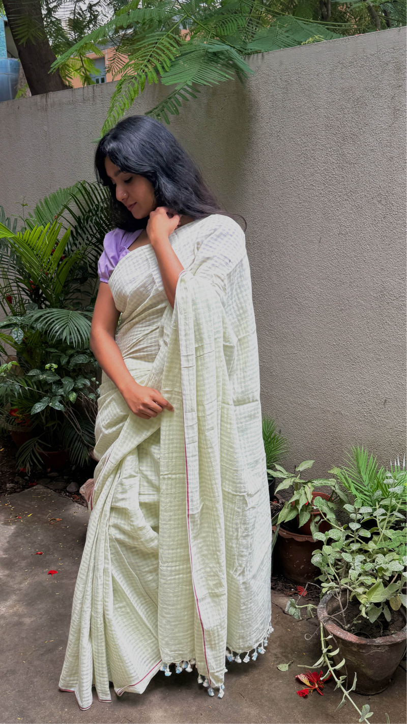 Handloom saree in soft green with fine checks and lightweight drape