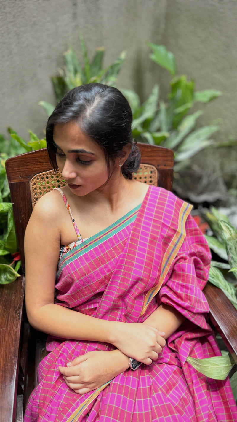 Model draped in VarsaaEdit Pink and Green Checked Cotton Saree – handwoven Bengal artistry in lightweight breathable cotton